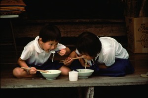 Asian boys eating noodles
